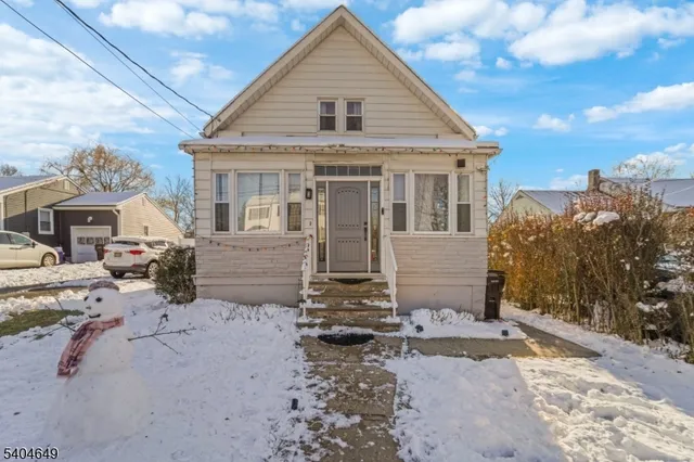 a view of a house with a yard covered in snow