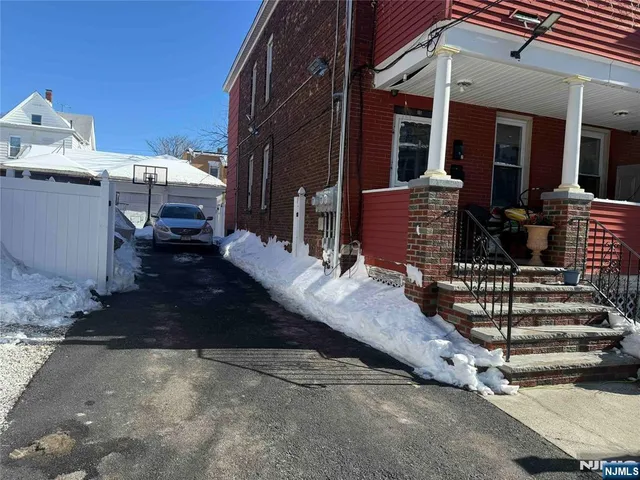 a view of a patio with table and chairs barbeque oven and potted plants