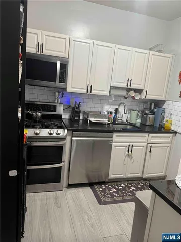 a kitchen with a sink a stove and cabinets