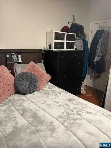 a bedroom with a bed and cabinet