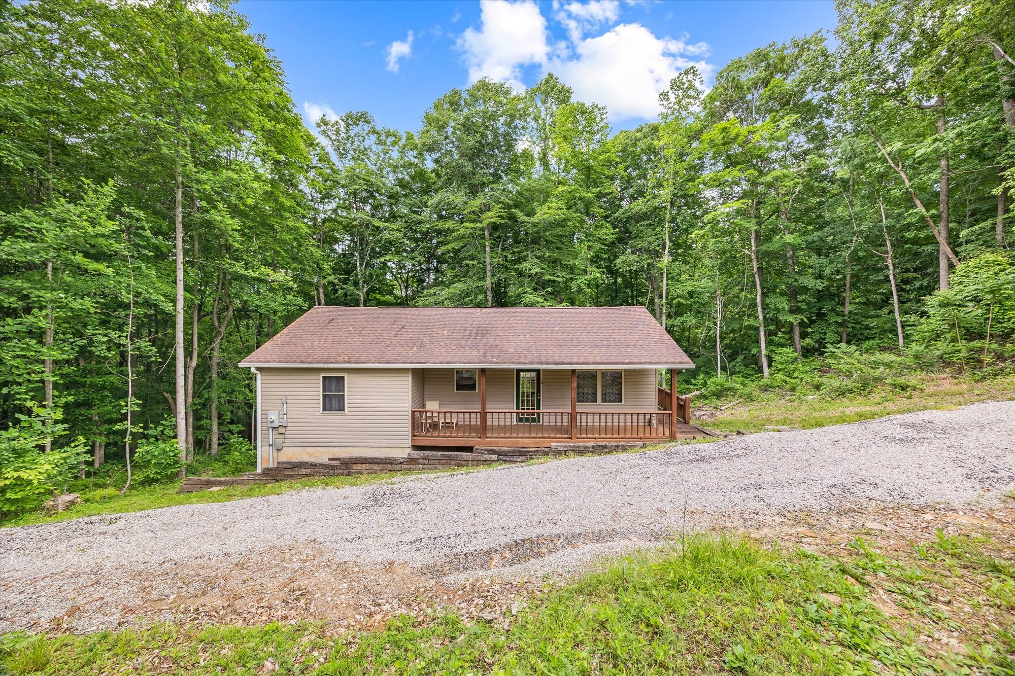 1103 Boles Beaty Road Alpine, TN 38543 - Photo 2 of 24 a house with trees in the background
