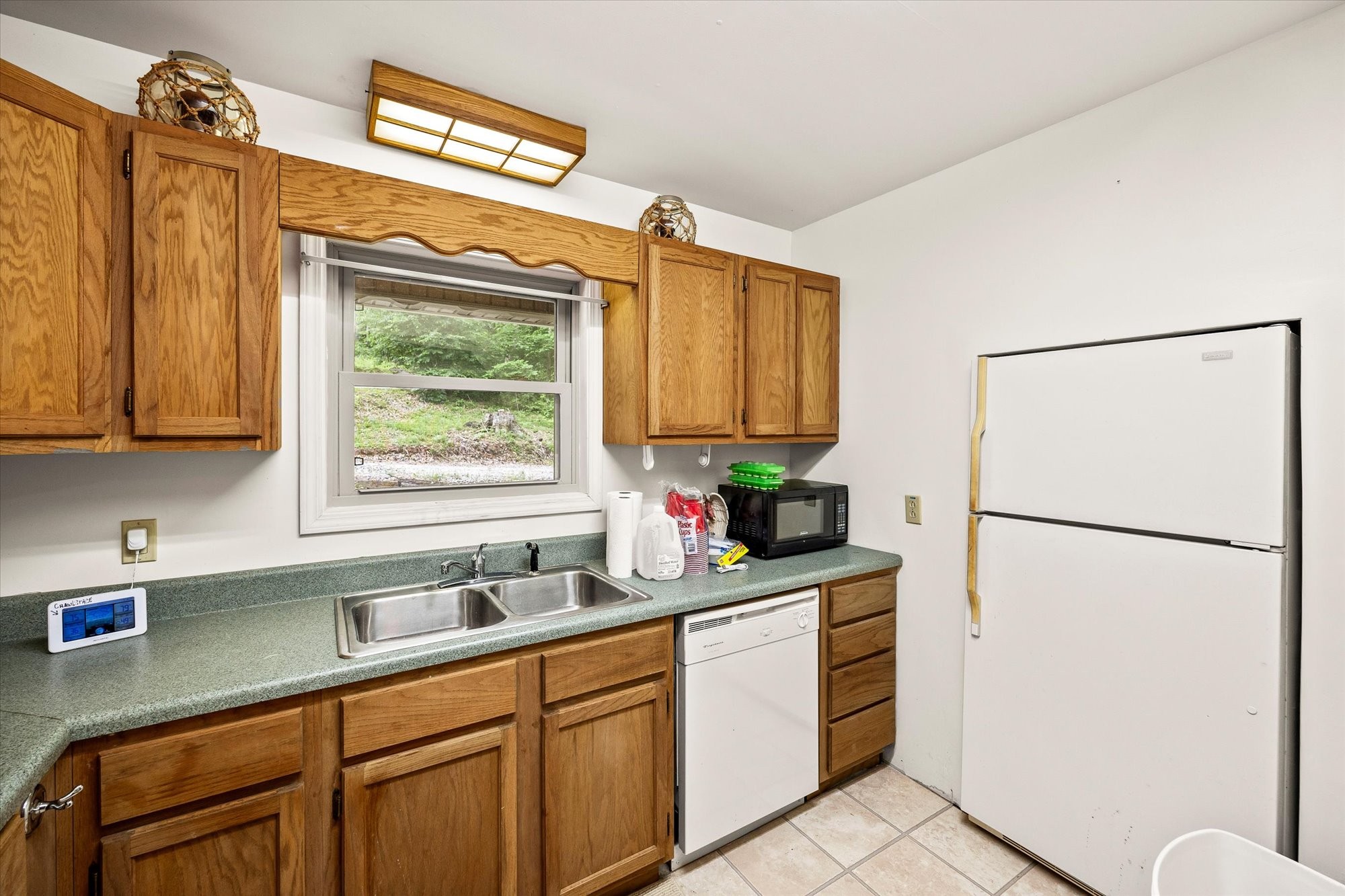 1103 Boles Beaty Road Alpine, TN 38543 - Photo 10 of 24 a kitchen with a refrigerator sink and cabinets