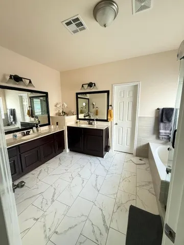 a kitchen with stainless steel appliances kitchen island granite countertop a sink and cabinets