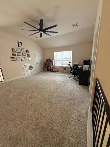 a view of a livingroom with furniture and a ceiling fan