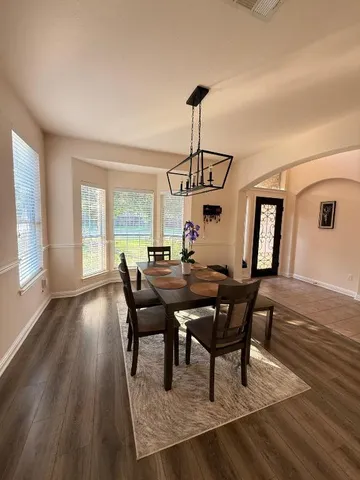 a view of a dining room with furniture window and wooden floor