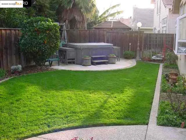 a view of a back yard with a table and a chairs