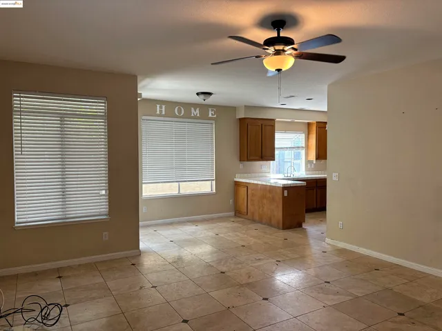 a kitchen with kitchen island granite countertop a stove a sink and a window