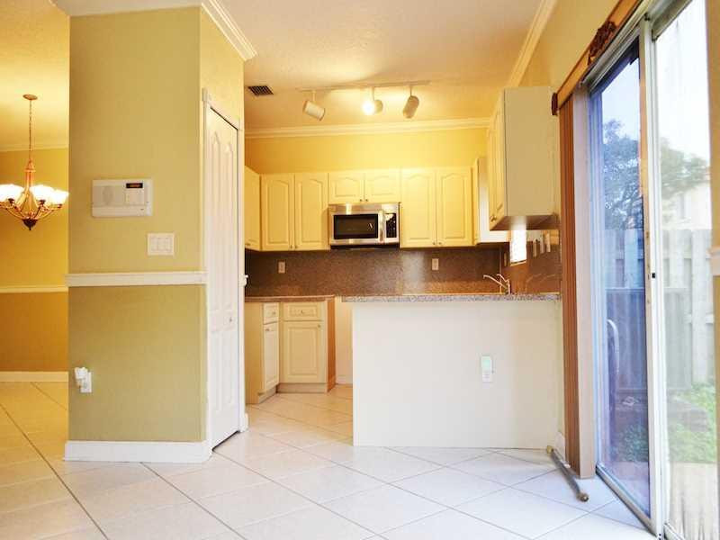 2899 Southwest 129th Terrace, Unit 2899 Miramar, FL 33027 - Photo 3 of 16 a bathroom with a granite countertop sink and a mirror