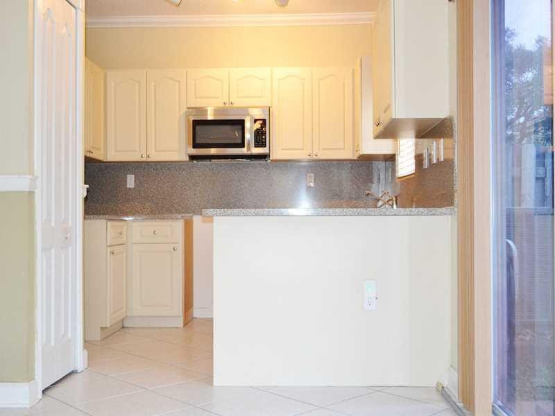 2899 Southwest 129th Terrace, Unit 2899 Miramar, FL 33027 - Photo 4 of 16 a kitchen with stainless steel appliances granite countertop a refrigerator and a stove