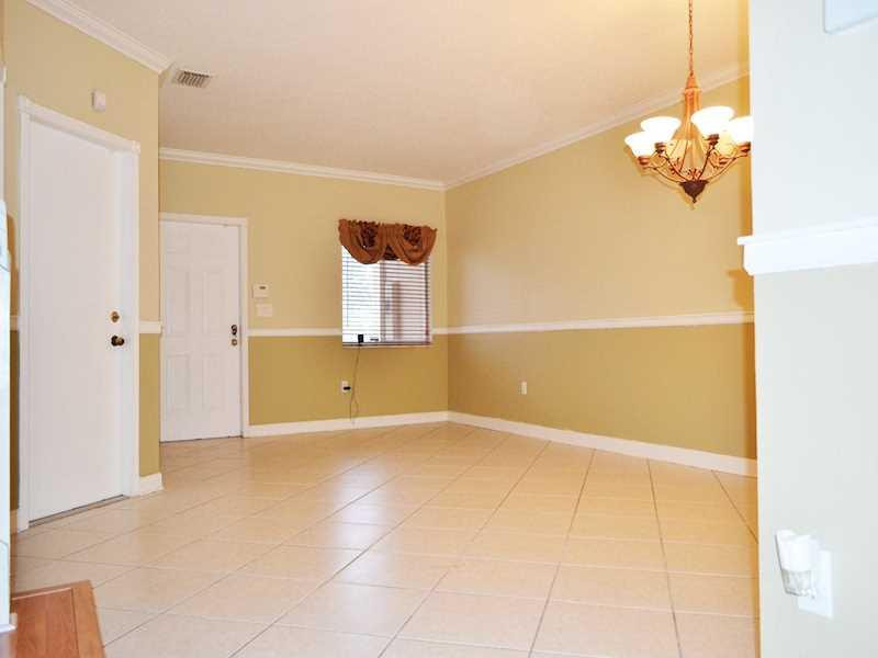 2899 Southwest 129th Terrace, Unit 2899 Miramar, FL 33027 - Photo 6 of 16 a view of a kitchen with a cabinet and a chandelier