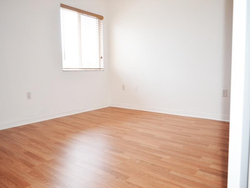 2899 Southwest 129th Terrace, Unit 2899 Miramar, FL 33027 - Photo 10 of 16 an empty room with wooden floor and windows