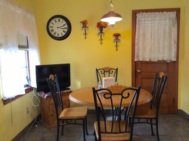 1101 Prospect Road Whitehall, PA 15227 - Photo 5 of 19 Kitchen eating area with ceramic flooring with door leading to cozy covered porch