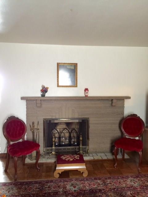 1101 Prospect Road Whitehall, PA 15227 - Photo 6 of 19 Log burning fireplace in the living room surrounded with parquet flooring
