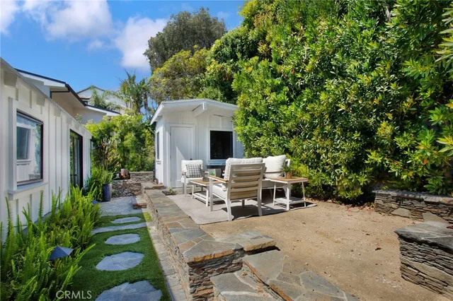 a view of a house with backyard stove and sitting area