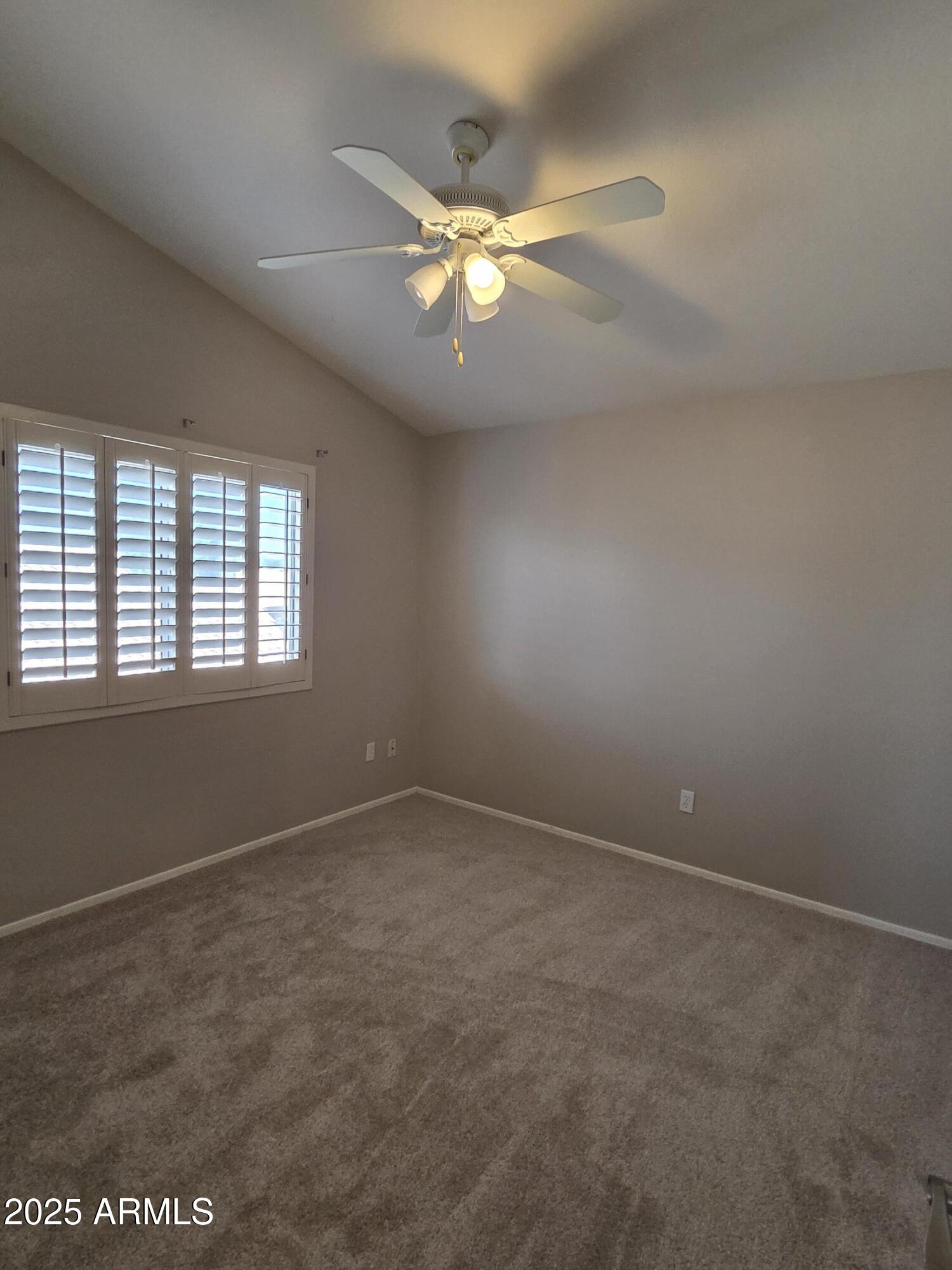 30651 North 44th Street Cave Creek, AZ 85331 - Photo 11 of 18 an empty room with a ceiling fan and window
