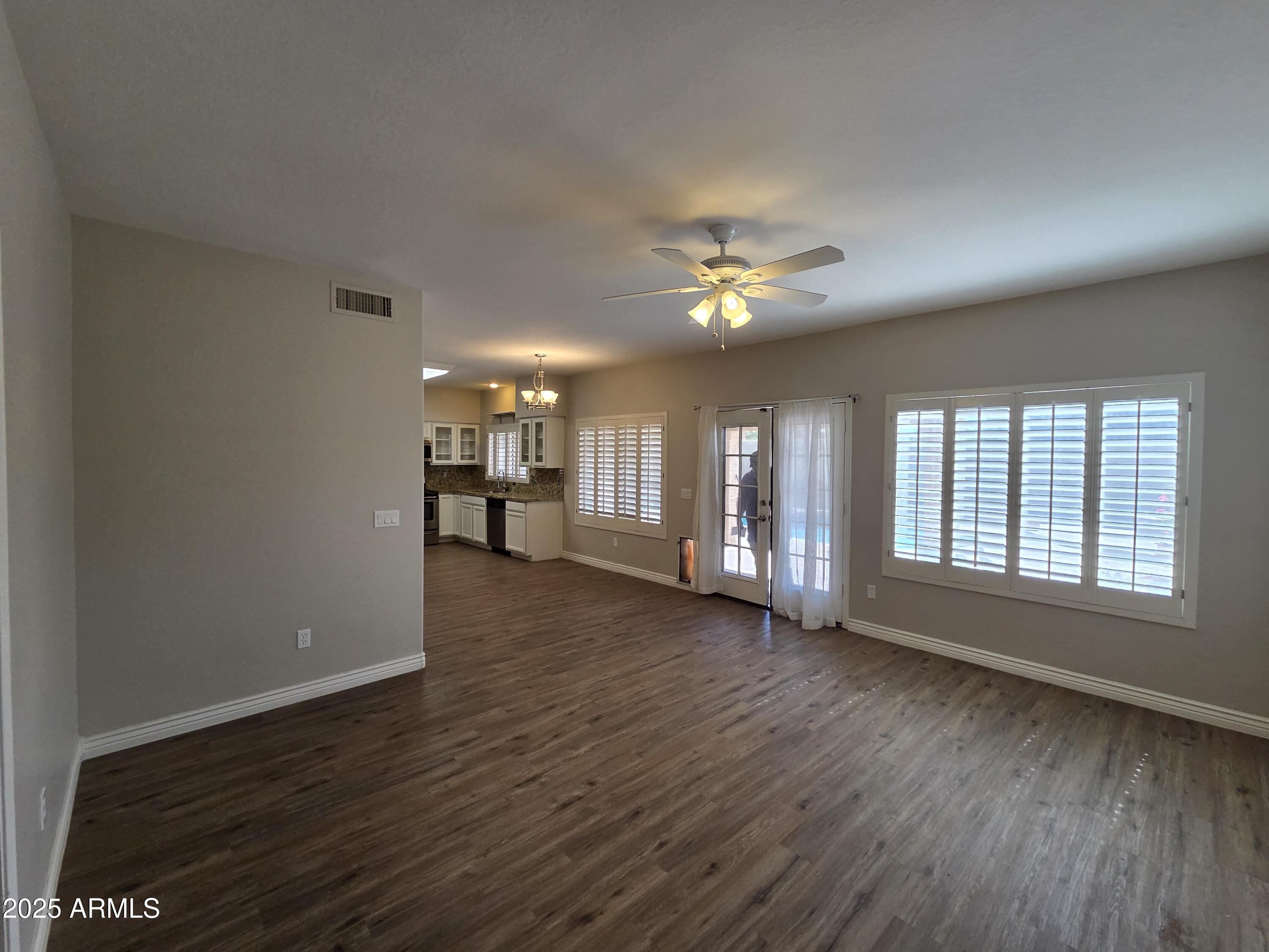30651 North 44th Street Cave Creek, AZ 85331 - Photo 2 of 18 a view of an empty room with a window and wooden floor