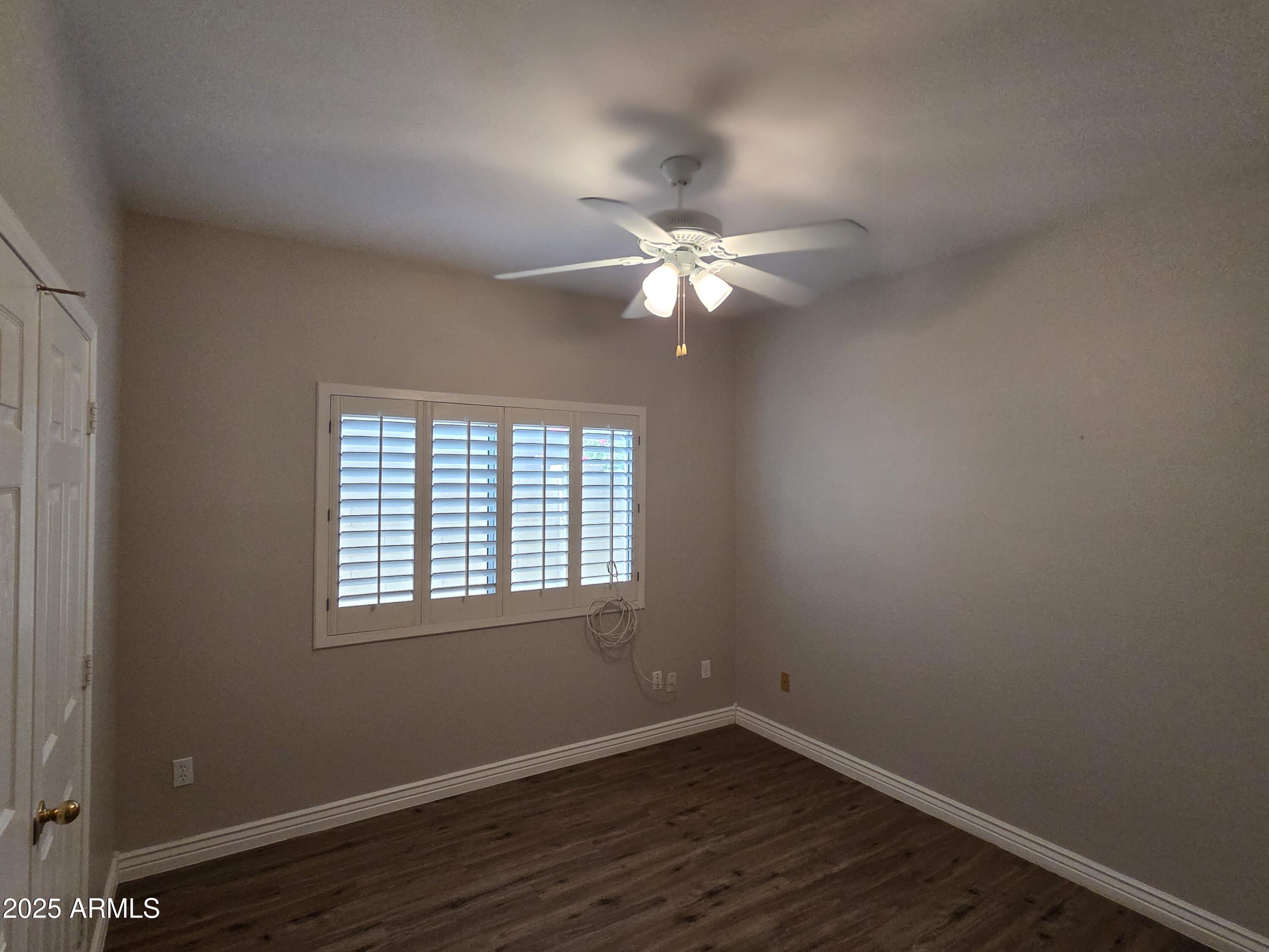 30651 North 44th Street Cave Creek, AZ 85331 - Photo 6 of 18 a view of an empty room with wooden floor and a window