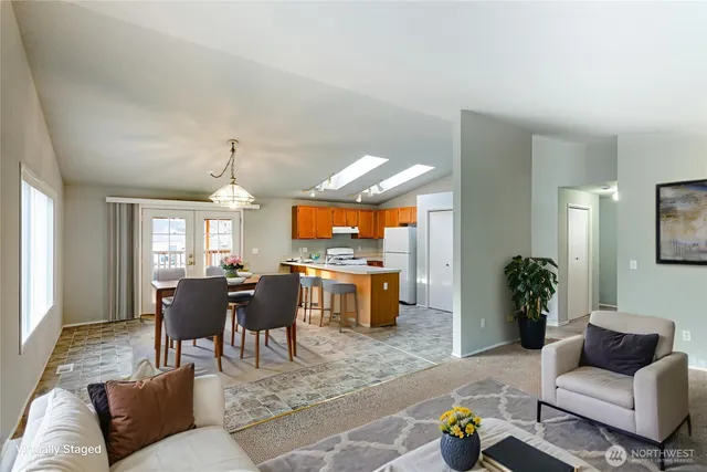 a living room with furniture and a dining room
