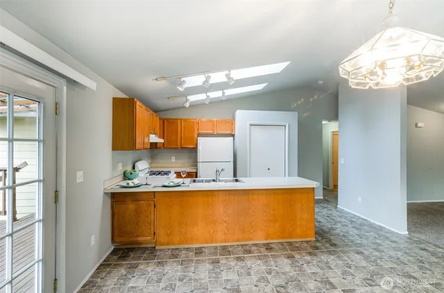 a view of a kitchen with kitchen island granite countertop living room