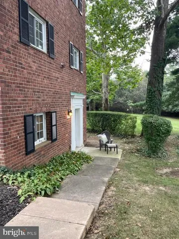 a view of a chair and table in backyard of the house