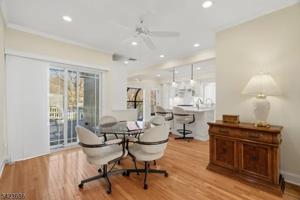 a living room with furniture a table and wooden floor