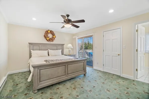 a room with a bed and a painting on the wall
