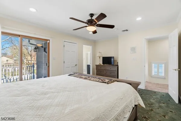 a bedroom with a large bed and a tv