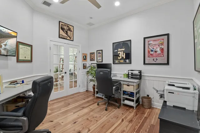 a large kitchen with a large counter top a sink stainless steel appliances and cabinets