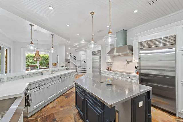 a view of a dining room with furniture large windows and wooden floor