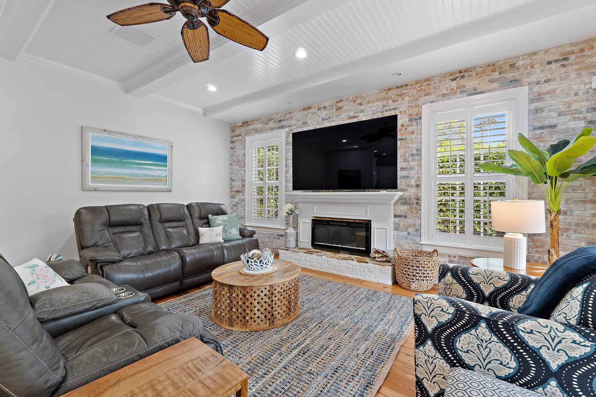 136 Via Catalunha Jupiter, FL 33458 - Photo 28 of 64 a living room with furniture a fireplace and a flat screen tv