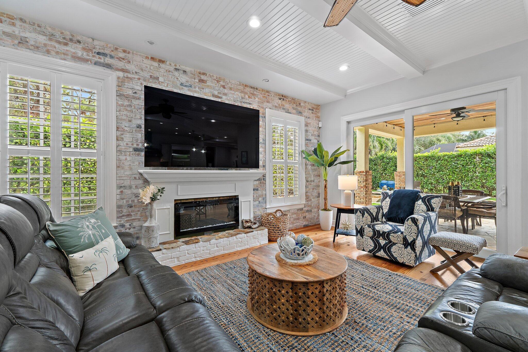 136 Via Catalunha Jupiter, FL 33458 - Photo 29 of 64 a living room with furniture a fireplace and a flat screen tv