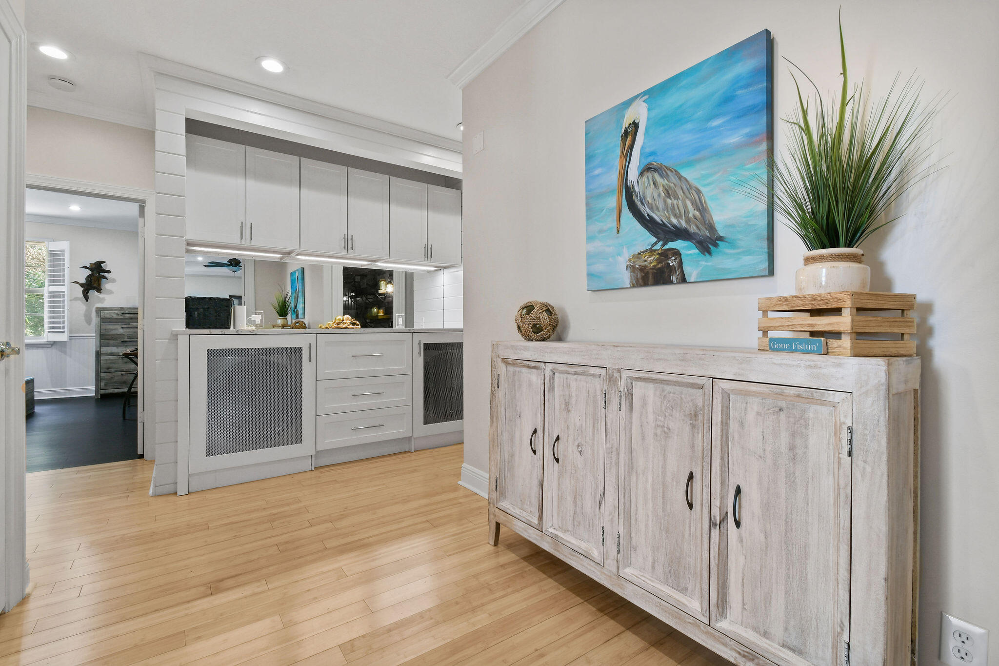 136 Via Catalunha Jupiter, FL 33458 - Photo 31 of 64 a kitchen with stainless steel appliances kitchen island wooden floors and white cabinets