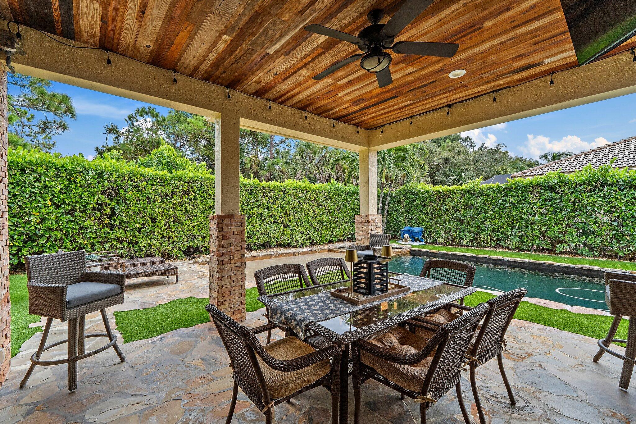 136 Via Catalunha Jupiter, FL 33458 - Photo 40 of 64 a view of an outdoor sitting area with furniture and umbrella