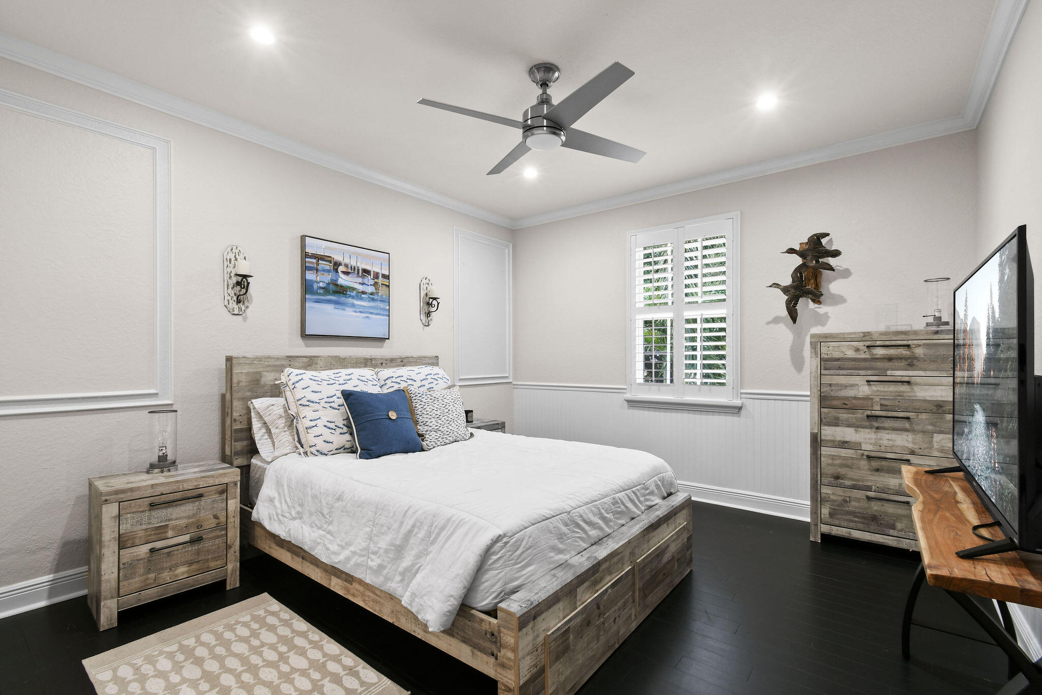 136 Via Catalunha Jupiter, FL 33458 - Photo 41 of 64 a bedroom with a bed and a chandelier