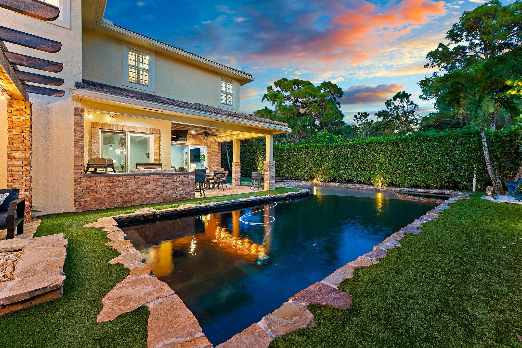 136 Via Catalunha Jupiter, FL 33458 - Photo 46 of 64 a view of a house with swimming pool and sitting area