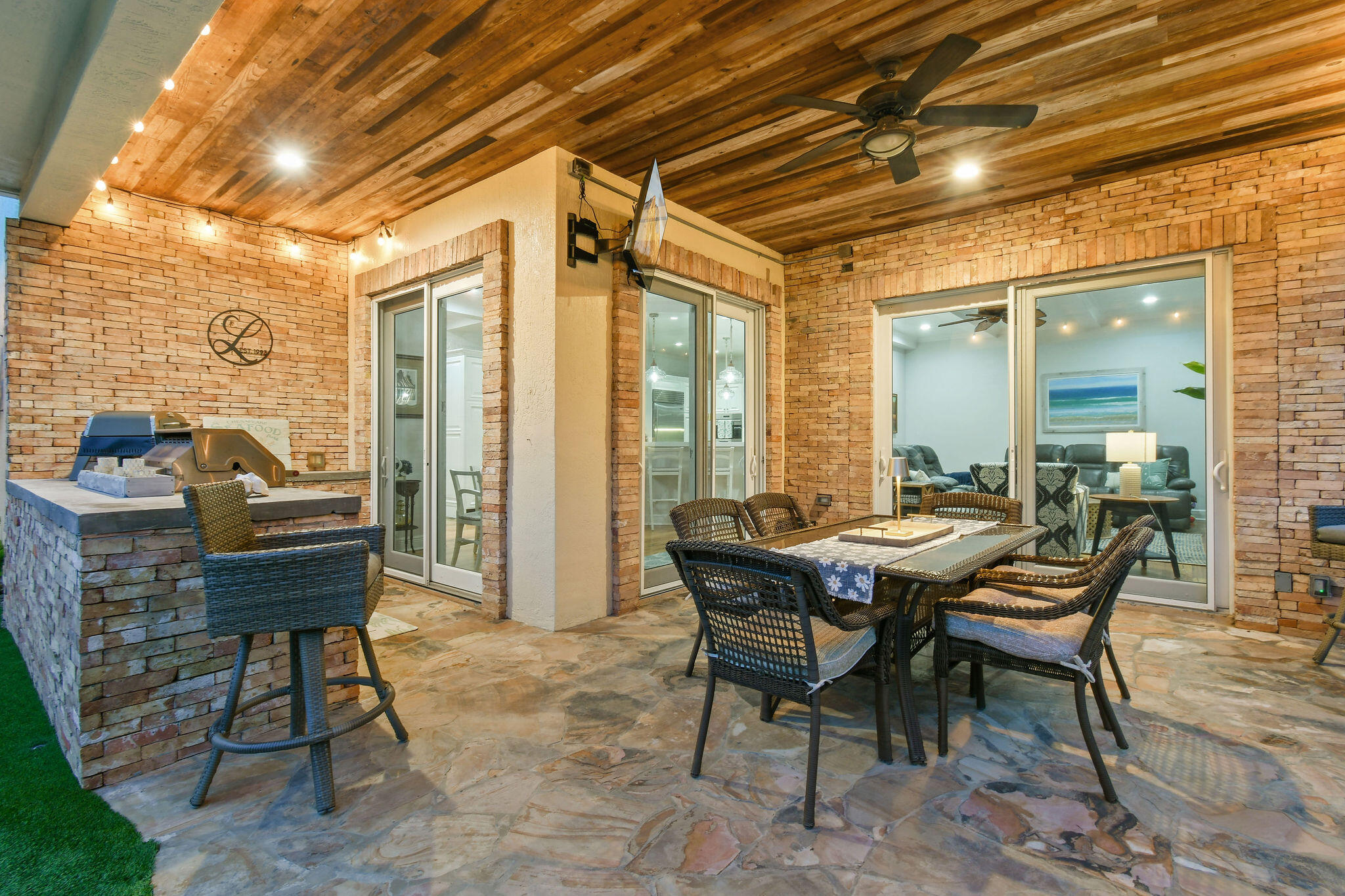 136 Via Catalunha Jupiter, FL 33458 - Photo 47 of 64 a patio with table and chairs and potted plants