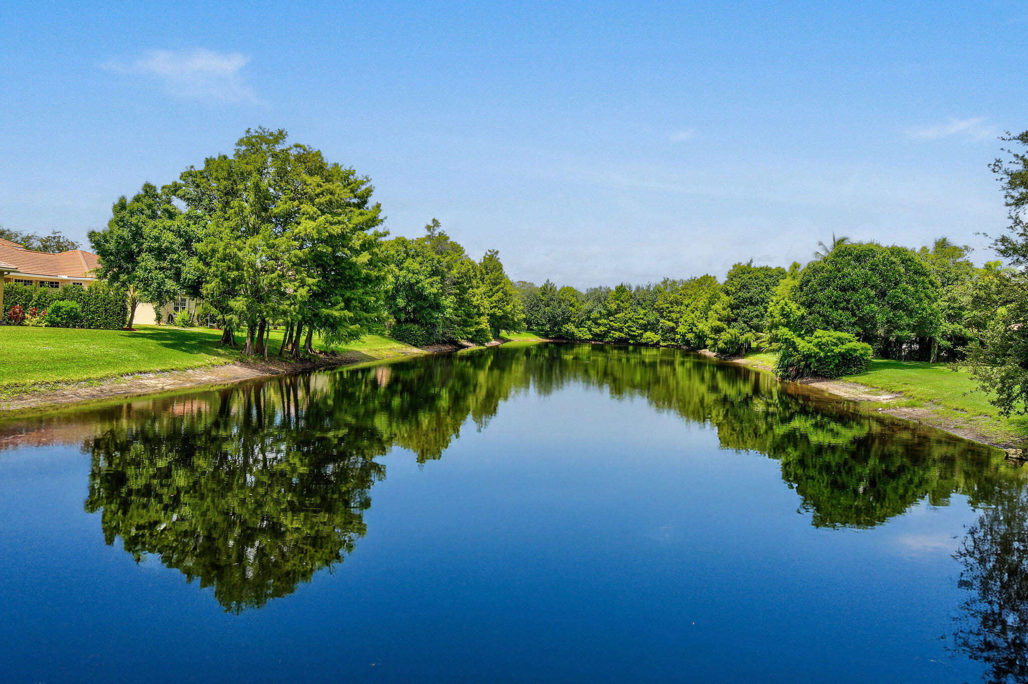 136 Via Catalunha Jupiter, FL 33458 - Photo 62 of 64 a view of a lake with a house in the background