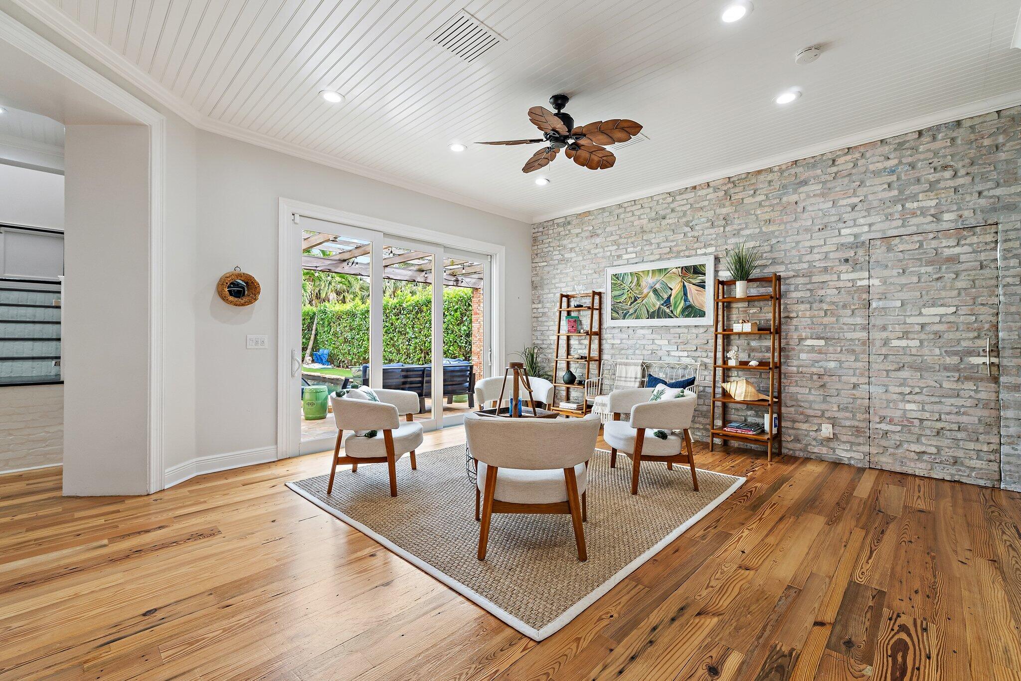 136 Via Catalunha Jupiter, FL 33458 - Photo 7 of 64 a living room with furniture a window and wooden floor