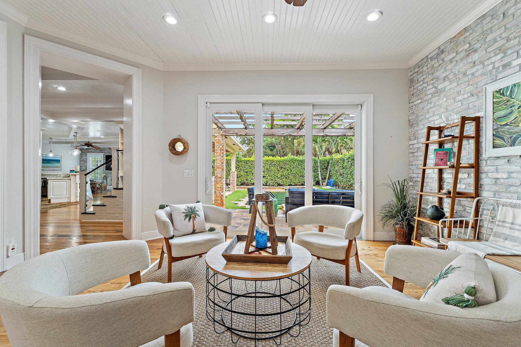 136 Via Catalunha Jupiter, FL 33458 - Photo 8 of 64 a living room with fireplace furniture and a large window