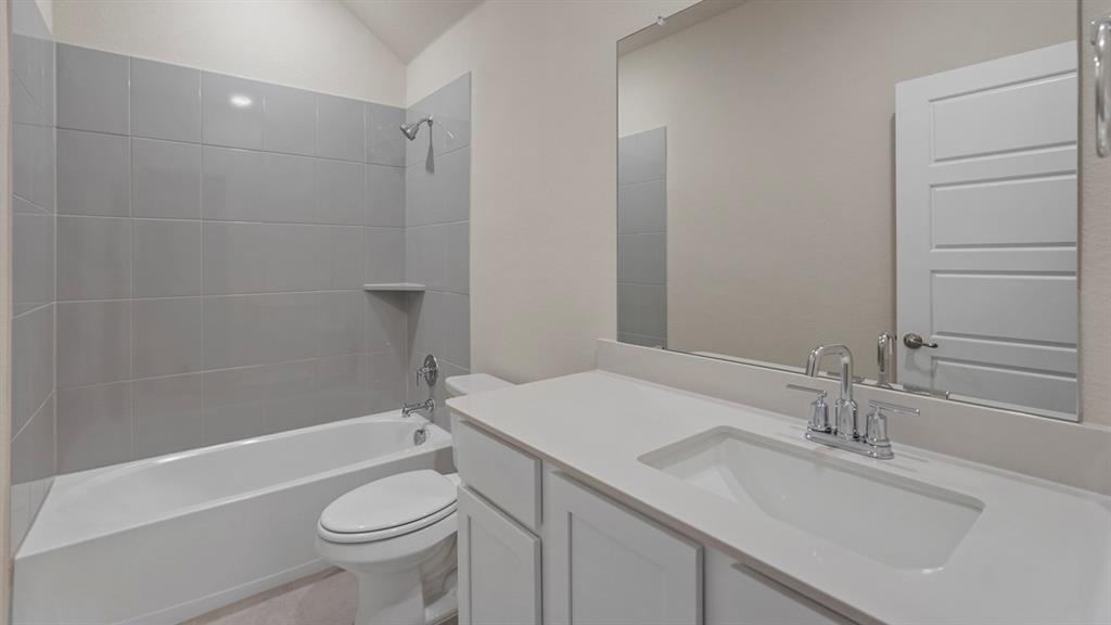 447 Epiphany Lane Lavon, TX 75166 - Photo 26 of 31 Bathroom featuring a white vanity with an integrated sink, polished chrome faucet, and expansive mirror