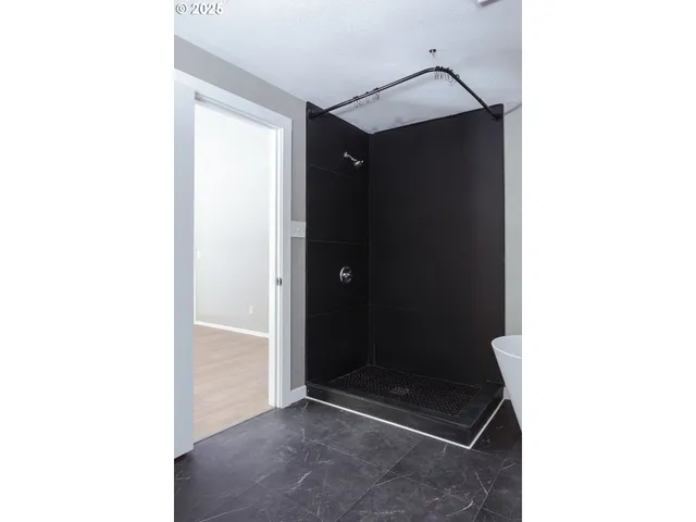 a bathroom with a glass shower door