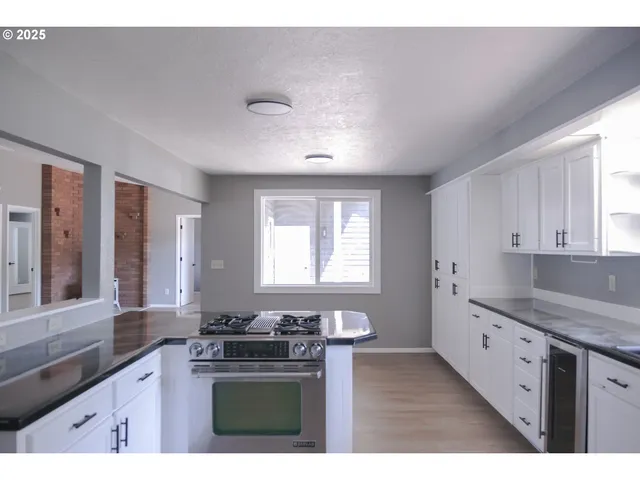 a kitchen with a sink stove and cabinets