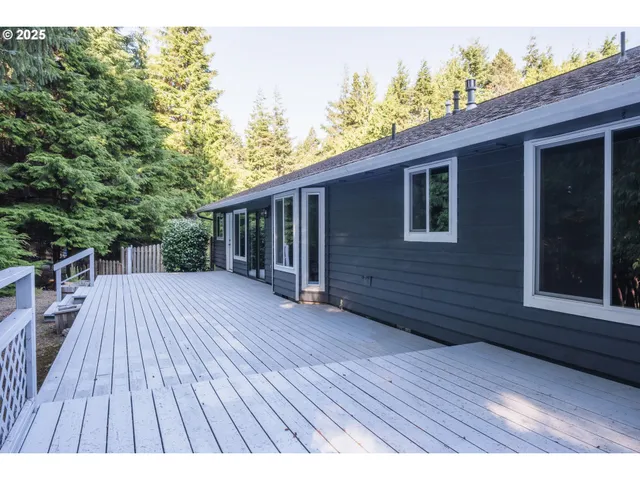 a view of backyard with a deck and wooden floor