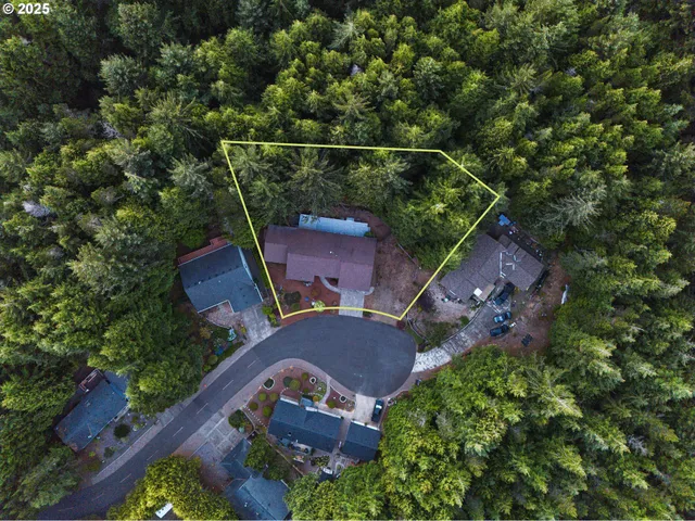 an aerial view of a house with a yard