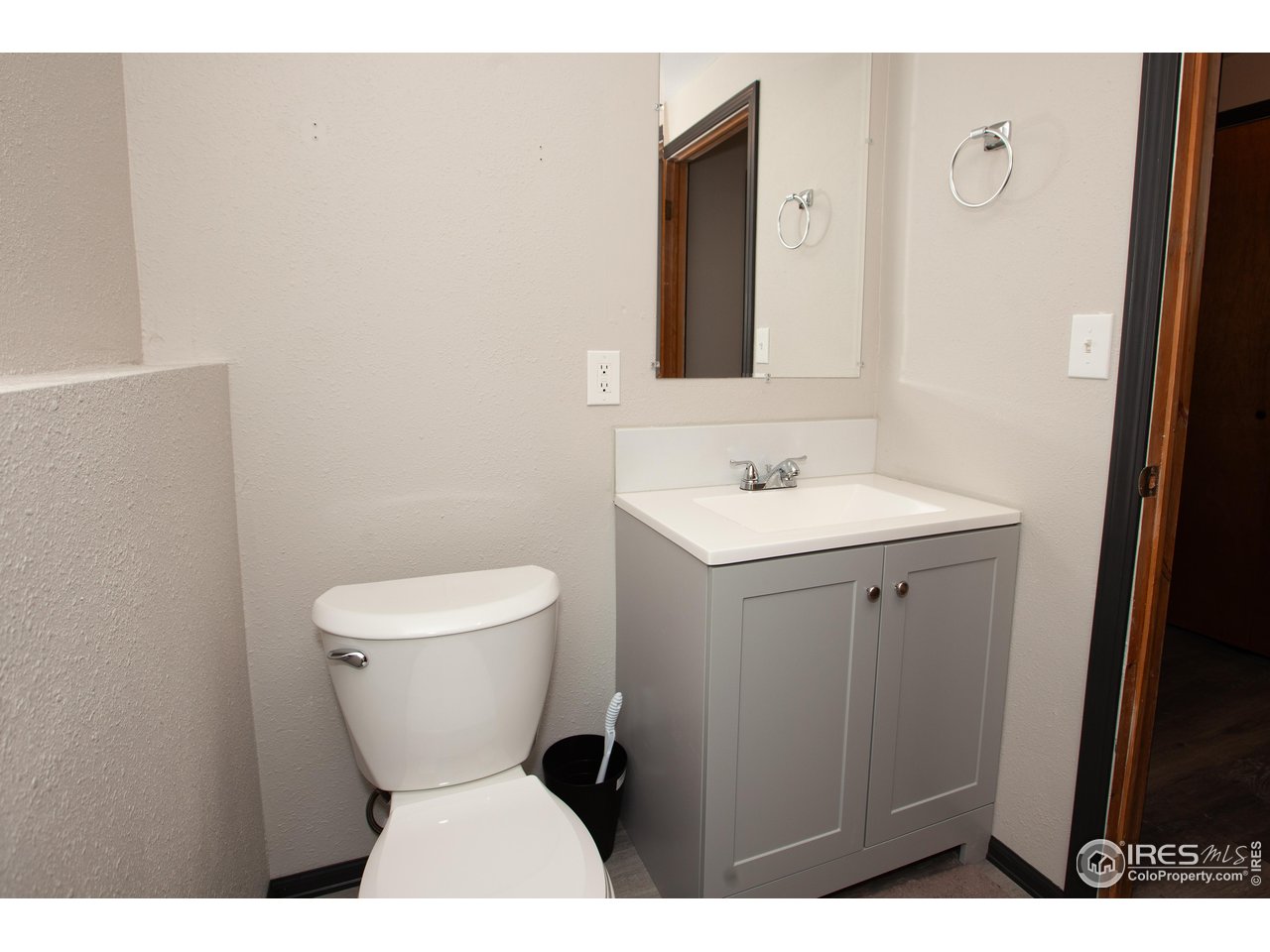 538 California Street Sterling, CO 80751 - Photo 30 of 33 a bathroom with a toilet sink and mirror