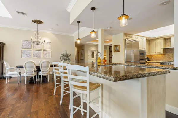 a kitchen with lots of counter space and chandelier
