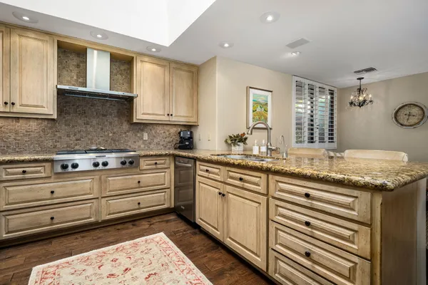 a kitchen with a refrigerator sink and cabinets