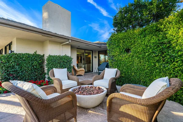 a view of a patio with table and chairs and potted plants