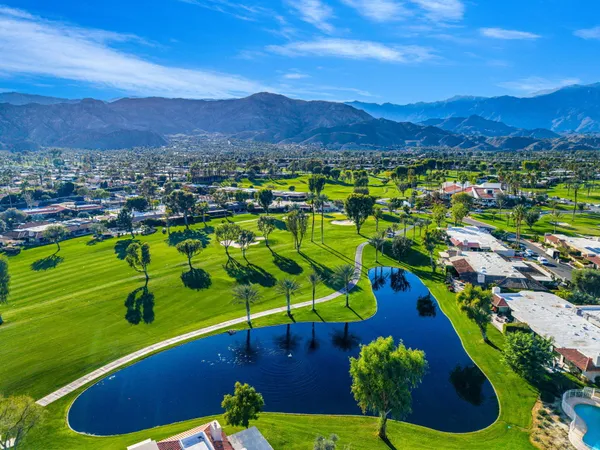 a view of a swimming pool with a yard and mountain view