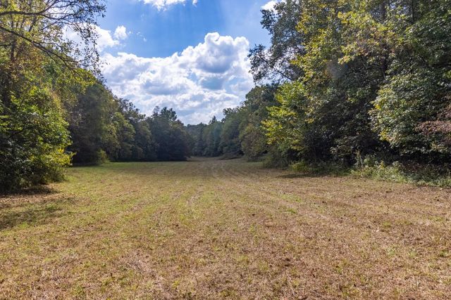 an aerial view of a house with a yard and lake view